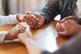 people holding hand in counselling