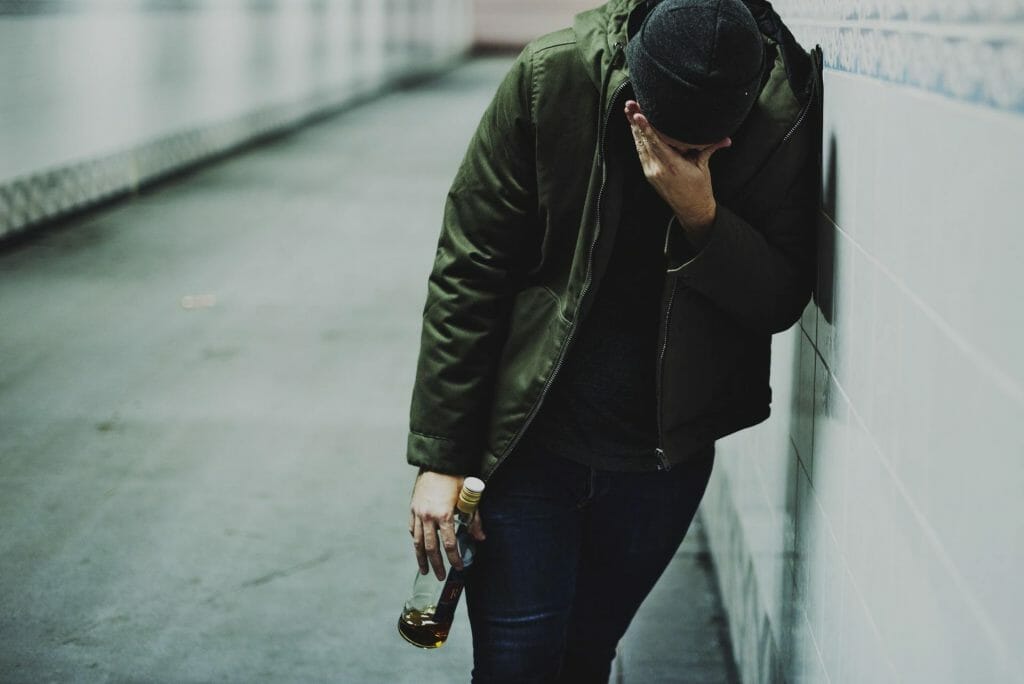 Man Holding Liquor Bottle Feeling Depressed