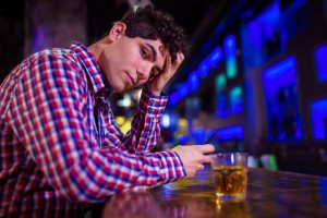 Portrait of sad man at bar counter