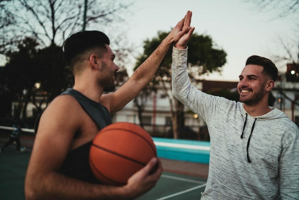 Two young friends playing basketball.